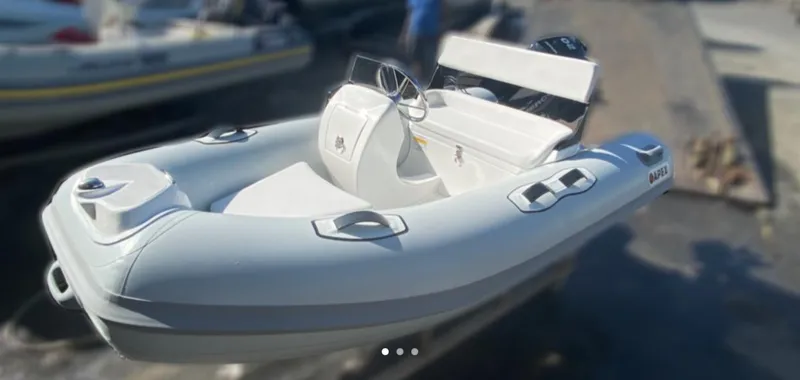 Slide: The Image of Apex A12 inflatable boat, 2021 model, docked on a sunny day. - 15