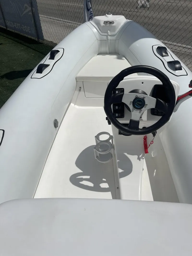 Slide: The Image of 2021 Apex A12 inflatable boat interior with steering wheel and seating. - 3
