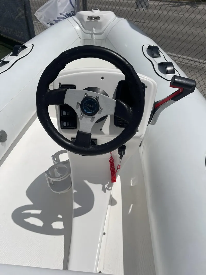 Slide: The Image of Apex A12 inflatable boat steering console, 2021 model, featuring a black steering wheel. - 6