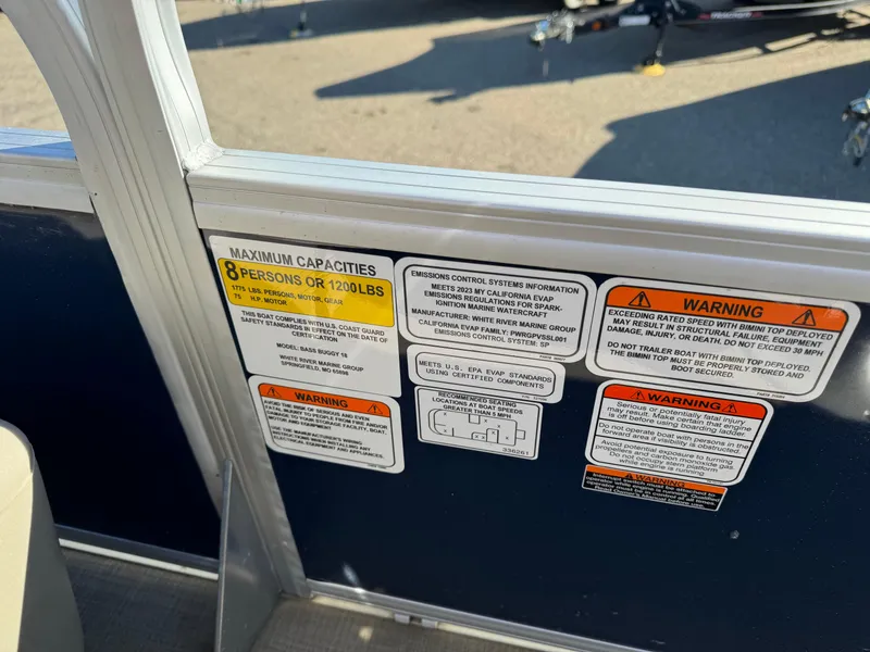 Slide: The Image of Capacity and warning labels on 2023 Sun Tracker Bass Buggy 18 DLX boat. - 12