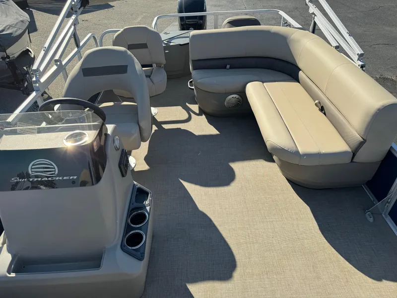 Slide: The Image of 2023 Sun Tracker Bass Buggy 18 DLX pontoon boat interior with seating and steering console. - 8