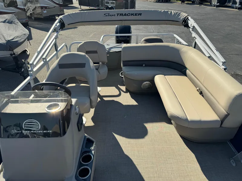 Slide: The Image of 2023 Sun Tracker Bass Buggy 18 DLX pontoon boat interior with seating and helm. - 9