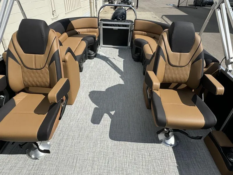Slide: The Image of 2025 Tahoe LTZ 2585 QL pontoon boat interior with luxurious tan and black seating. - 10
