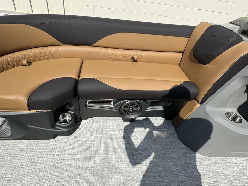 Slide: The Image of 2025 Tahoe LTZ 2585 QL boat interior with tan and black seating. - 11