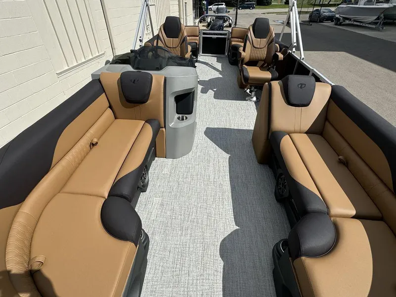 Slide: The Image of 2025 Tahoe LTZ 2585 QL pontoon boat interior with tan and black seating. - 12