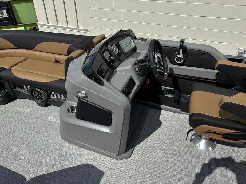 Slide: The Image of 2025 Tahoe LTZ 2585 QL boat interior with helm and seating area. - 13
