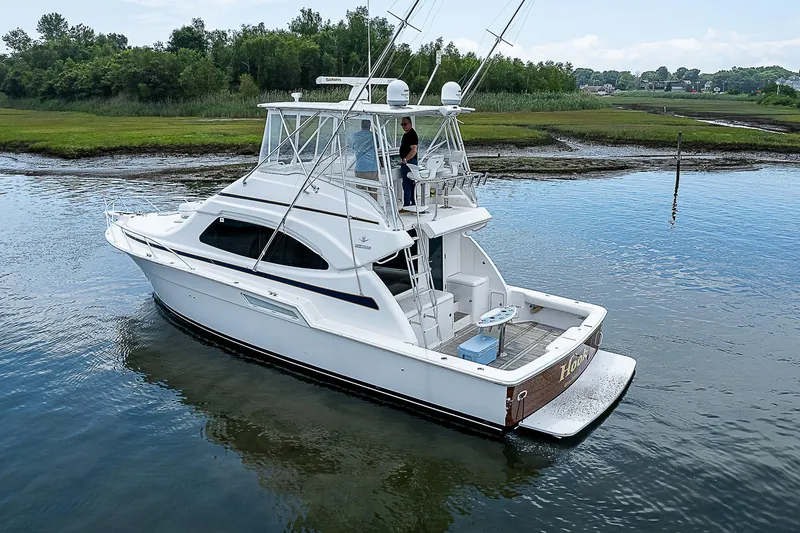 Slide: The Image of 2005 Bertram 450 Convertible yacht on calm water, side view. - 14