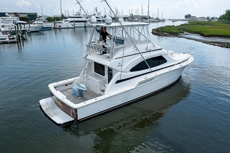 Slide: The Image of 2005 Bertram 450 Convertible yacht cruising in a marina. - 15