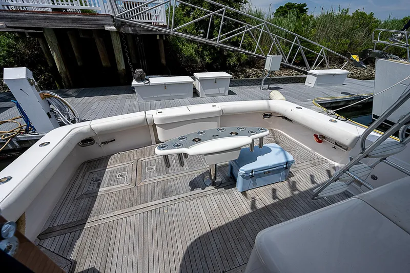 Slide: The Image of 2005 Bertram 450 Convertible yacht deck with seating and fishing equipment. - 16