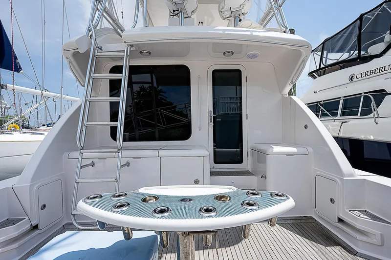 Slide: The Image of 2005 Bertram 450 Convertible yacht deck with ladder and seating area. - 18