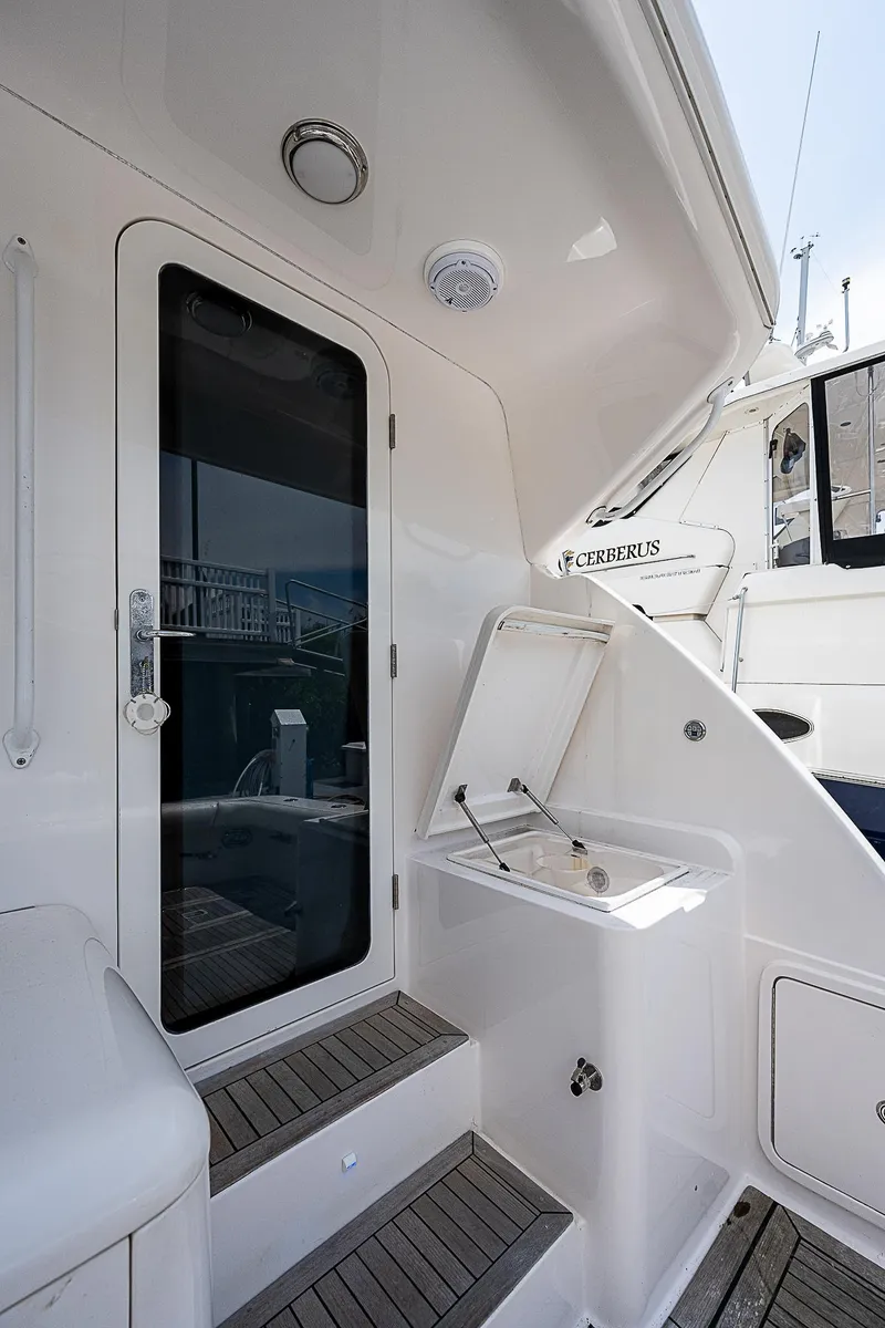 Slide: The Image of 2005 Bertram 450 Convertible yacht, sleek design, outdoor stairs, and modern amenities. - 21