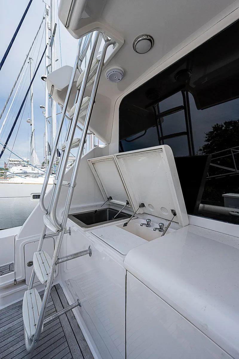 Slide: The Image of 2005 Bertram 450 Convertible yacht with ladder and open storage compartment. - 22