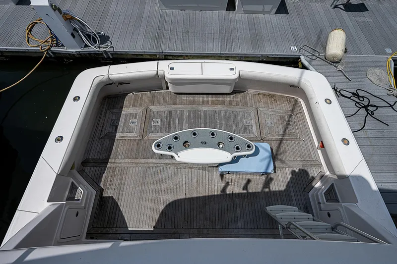 Slide: The Image of Bertram 450 Convertible 2005 yacht deck with fishing rod holders and seating area. - 23
