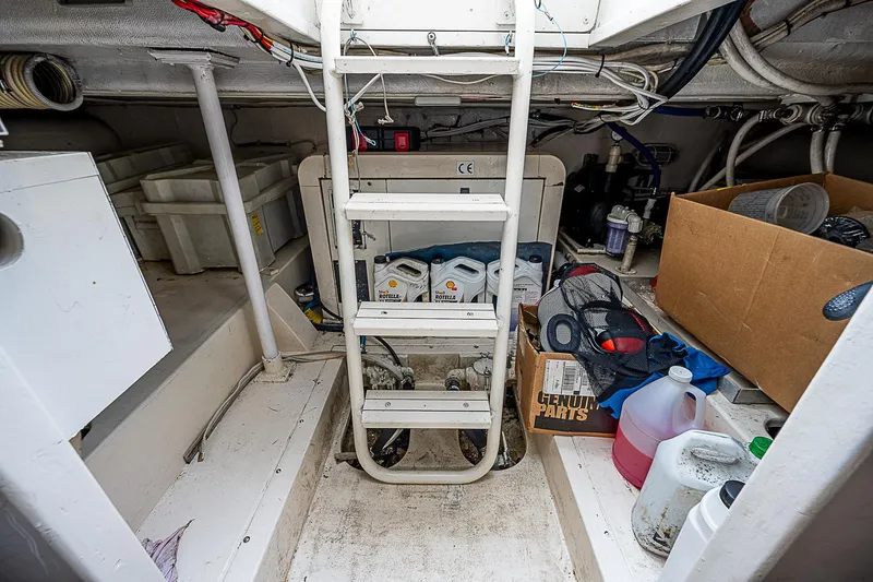 Slide: The Image of Engine room of 2005 Bertram 450 Convertible with storage and maintenance supplies. - 24