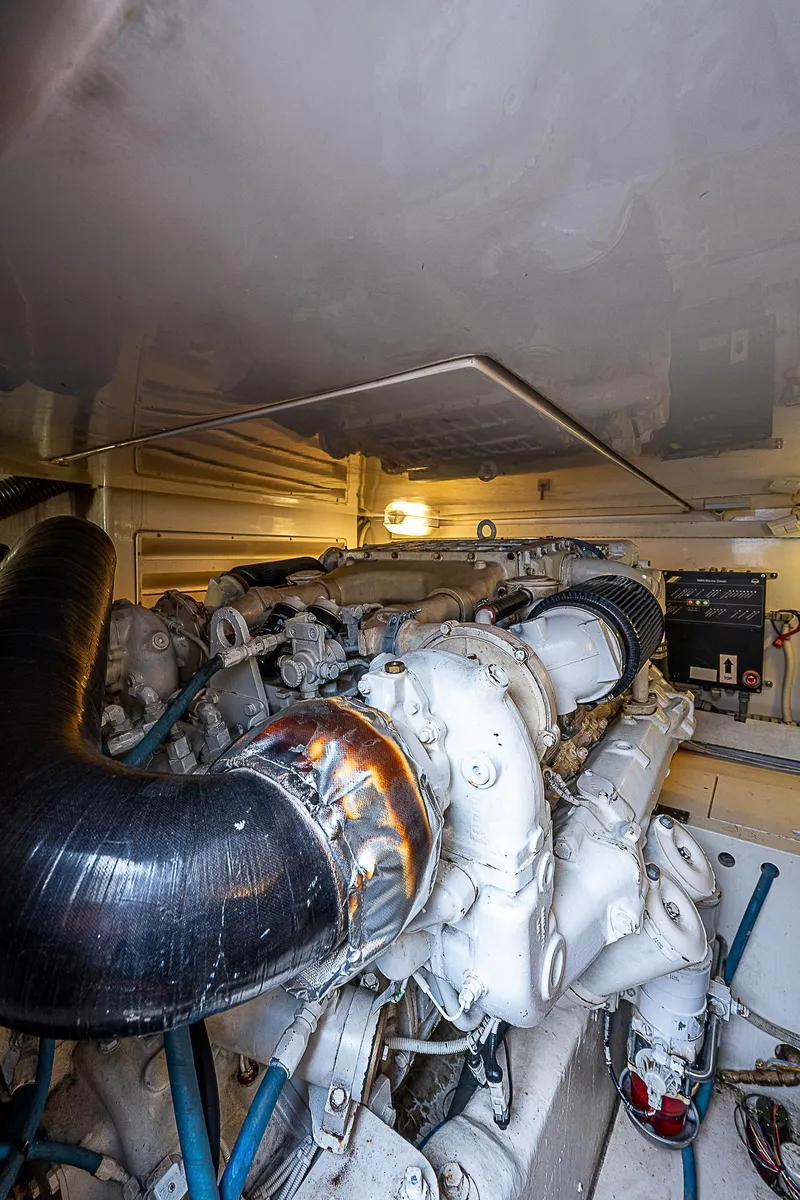 Slide: The Image of 2005 Bertram 450 Convertible engine room with visible machinery and components. - 28