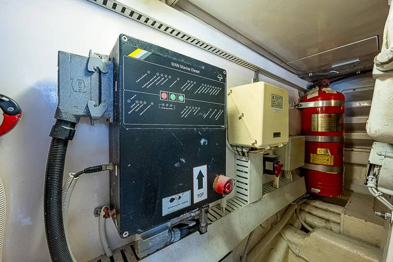 Slide: The Image of Engine room of 2005 Bertram 450 Convertible with control panel and fire extinguisher. - 31