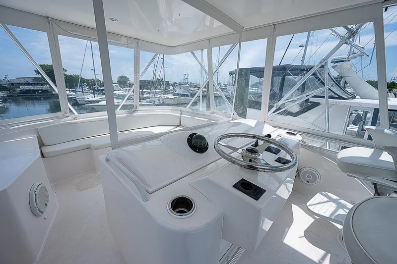 Slide: The Image of Interior helm of 2005 Bertram 450 Convertible yacht, featuring sleek design and marina view. - 39
