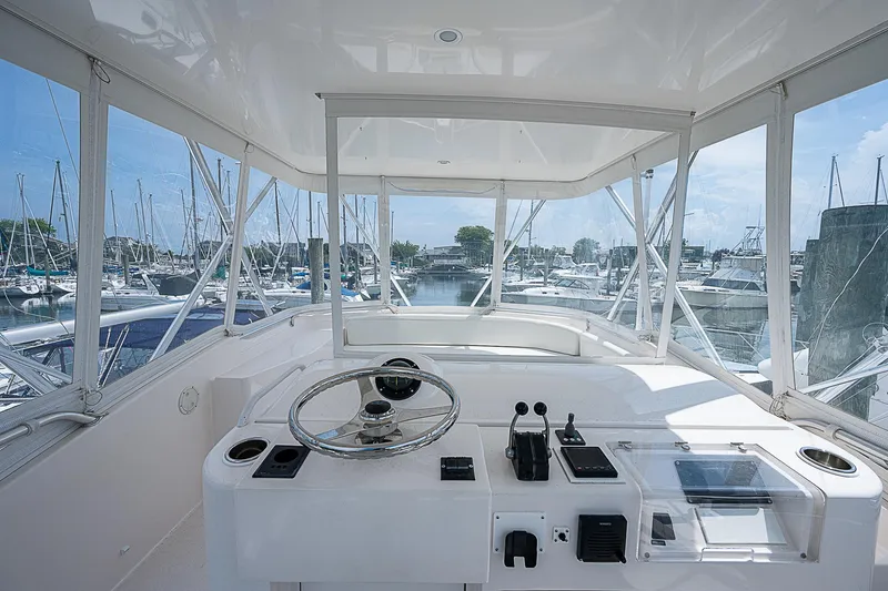 Slide: The Image of 2005 Bertram 450 Convertible yacht helm with marina view. - 40