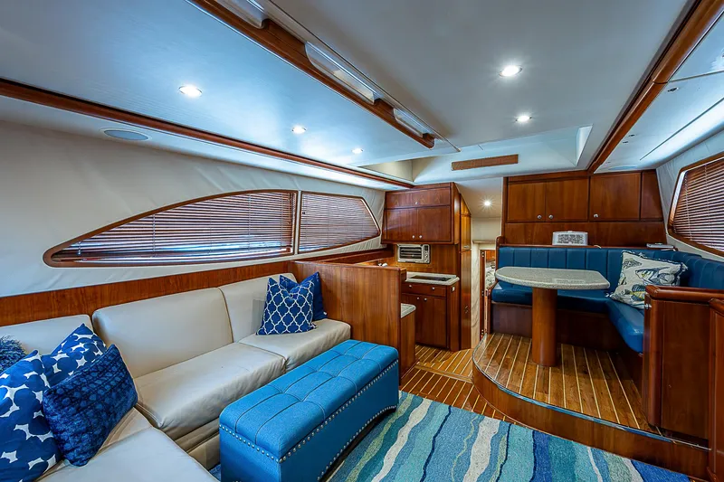 Slide: The Image of Luxurious interior of 2005 Bertram 450 Convertible yacht with modern seating and wood finishes. - 42