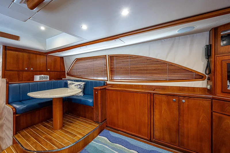 Slide: The Image of Luxurious interior of 2005 Bertram 450 Convertible yacht with wood finishes and blue seating. - 43