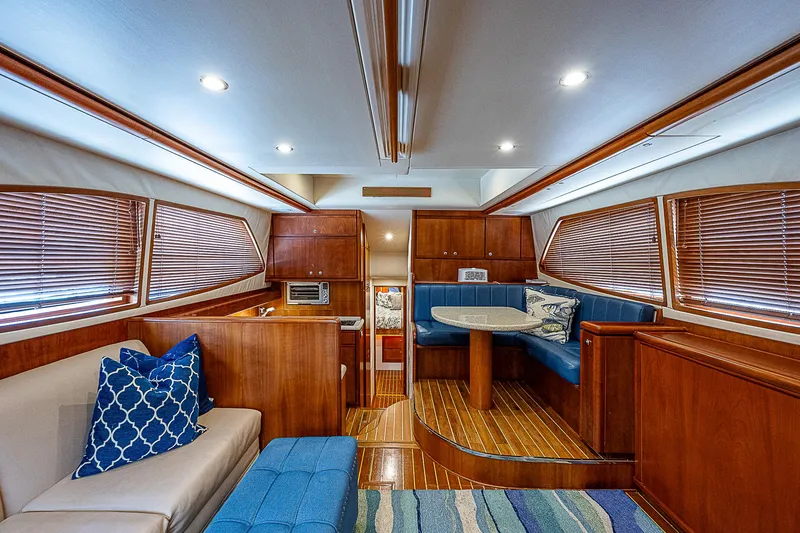 Slide: The Image of Luxurious interior of 2005 Bertram 450 Convertible yacht with wood finishes and blue accents. - 44
