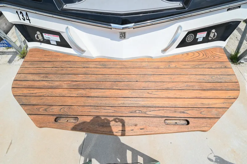 Slide: The Image of 2018 MasterCraft XT23 swim platform with wood finish and metal accents. - 10