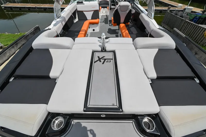Slide: The Image of 2018 MasterCraft XT23 boat interior with sleek seating and modern design. - 14