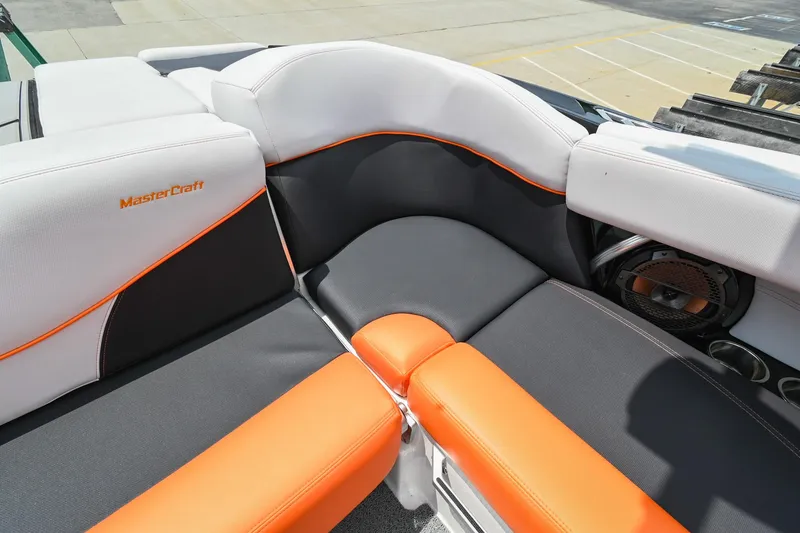 Slide: The Image of 2018 MasterCraft XT23 boat interior with orange and gray seating. - 20