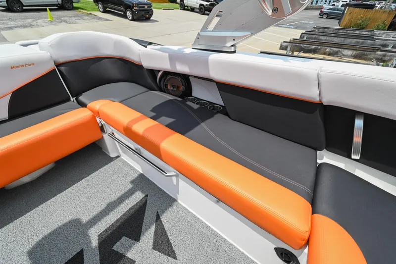 Slide: The Image of 2018 MasterCraft XT23 boat interior with orange and black seating. - 25