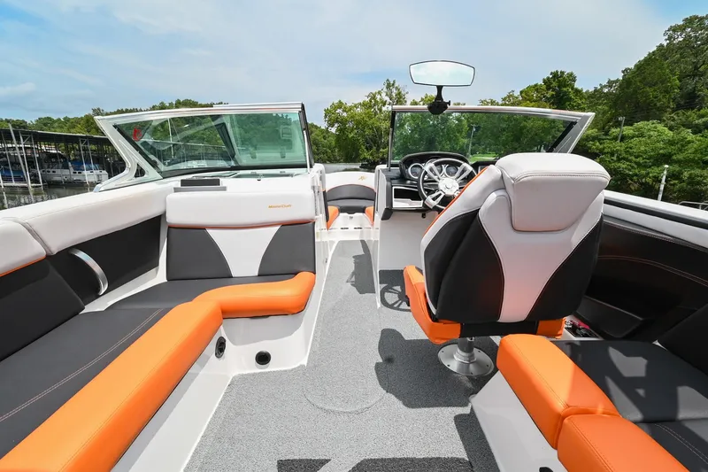 Slide: The Image of 2018 MasterCraft XT23 boat interior with orange and gray seating, sleek design. - 27
