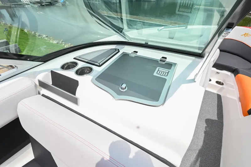 Slide: The Image of 2018 MasterCraft XT23 boat dashboard with storage compartment and cup holders. - 30