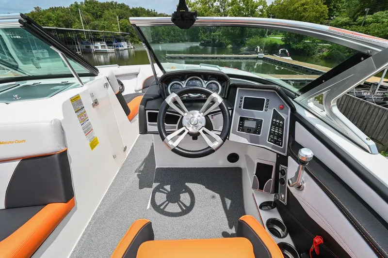 Slide: The Image of 2018 MasterCraft XT23 boat cockpit with modern steering and controls. - 32
