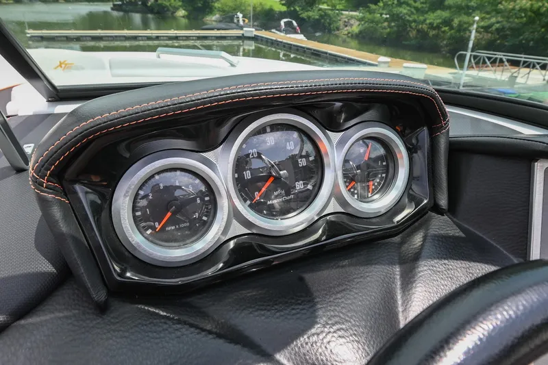 Slide: The Image of 2018 MasterCraft XT23 dashboard with three analog gauges, black leather trim. - 33