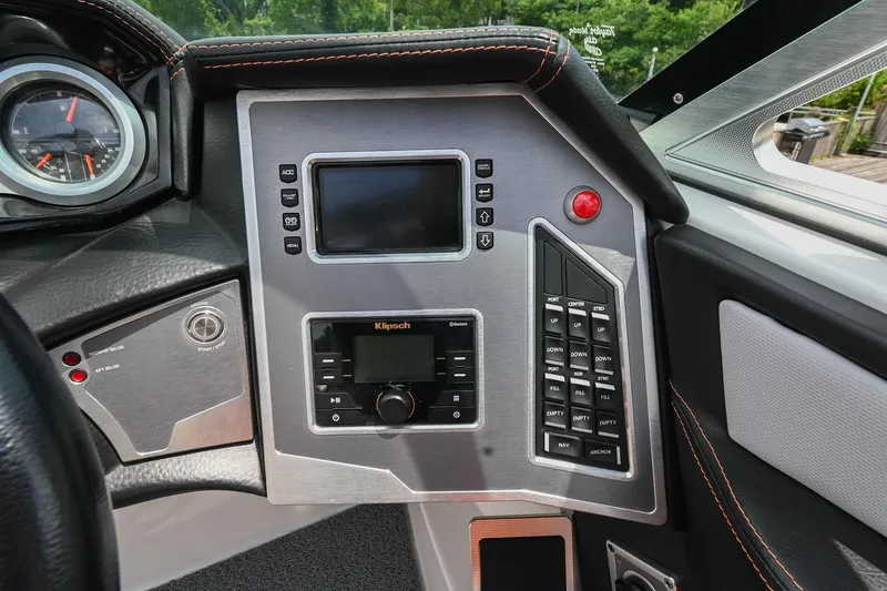 Slide: The Image of 2018 MasterCraft XT23 dashboard with control panel and display screen. - 34