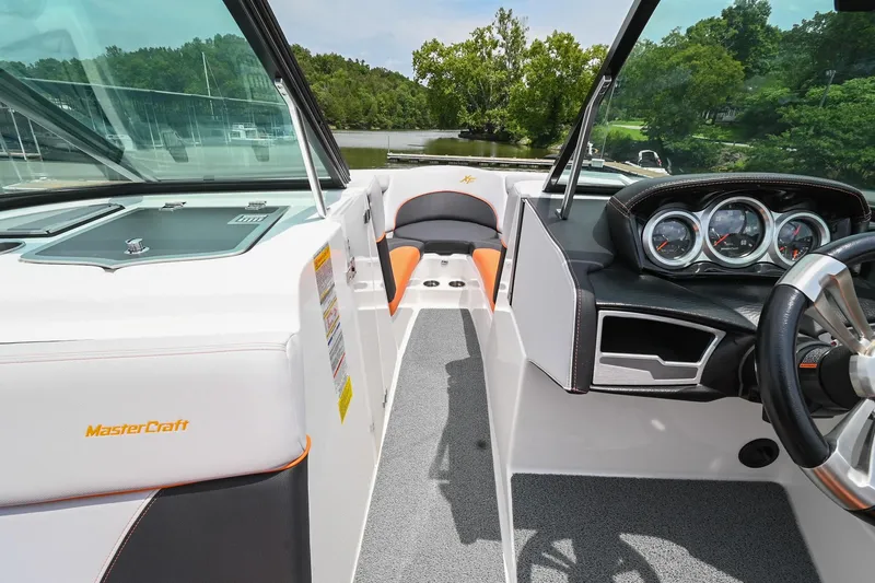 Slide: The Image of 2018 MasterCraft XT23 boat interior with dashboard and seating, featuring sleek design and modern controls. - 36