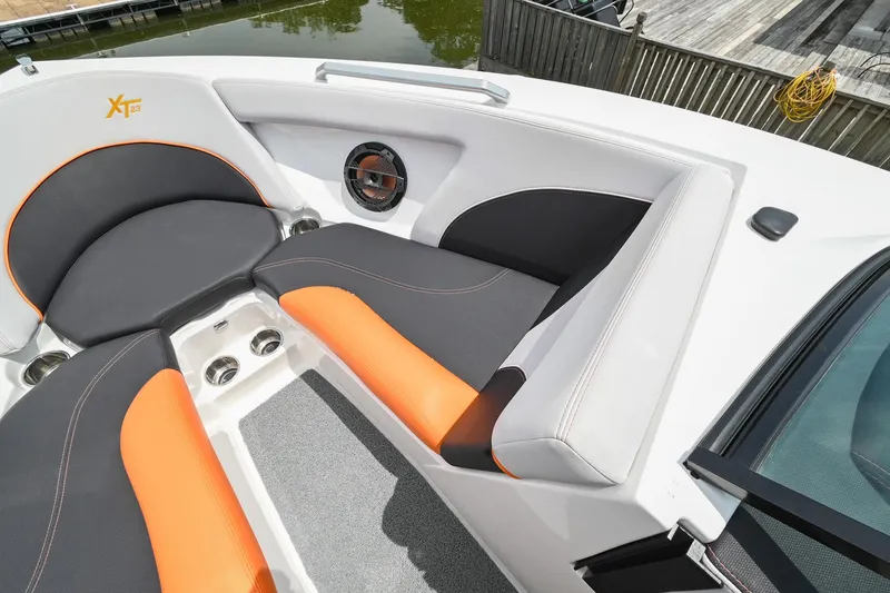 Slide: The Image of 2018 MasterCraft XT23 boat interior with orange and gray seating. - 40