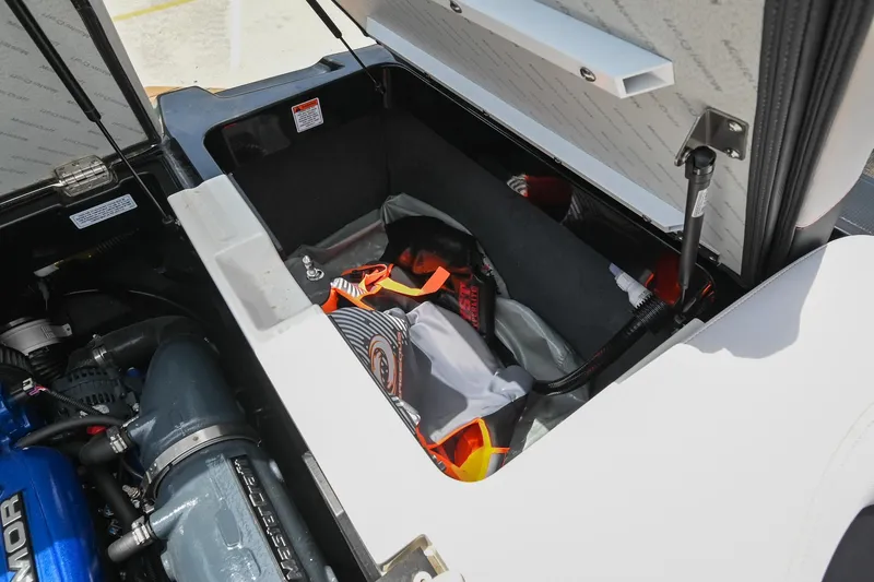 Slide: The Image of Open storage compartment in 2018 MasterCraft XT23 boat, showing engine and gear. - 44