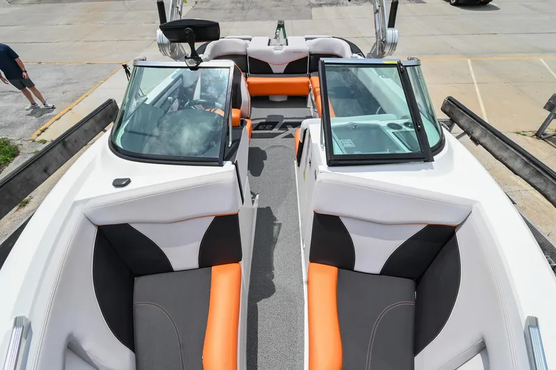Slide: The Image of 2018 MasterCraft XT23 boat interior with orange and black seating. - 9