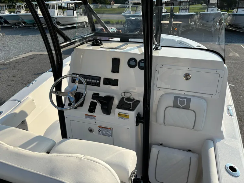 Slide: The Image of 2025 Sea Fox 248 Side Console boat interior with steering wheel and control panel. - 10
