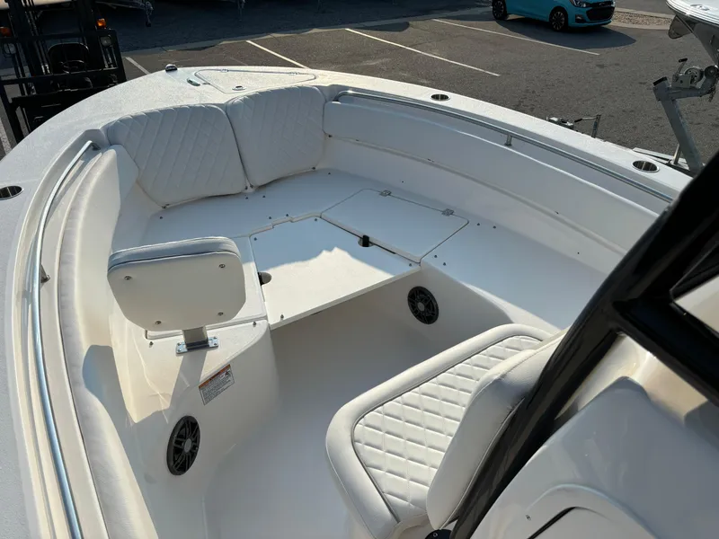 Slide: The Image of 2025 Sea Fox 248 Side Console boat interior with white seating and storage compartments. - 11