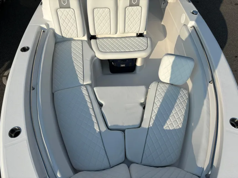 Slide: The Image of 2025 Sea Fox 248 Side Console boat interior with white cushioned seating. - 15