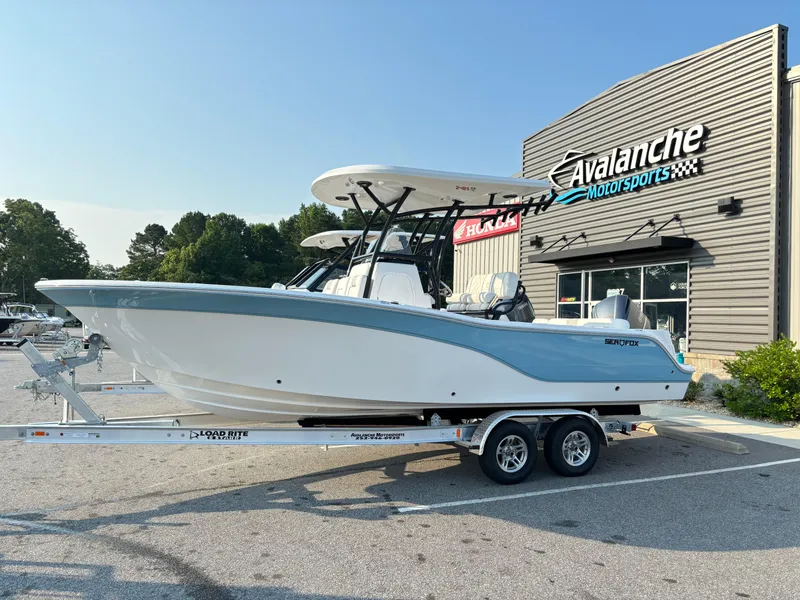 Slide: The Image of 2025 Sea Fox 248 Side Console boat on trailer outside Avalanche Motorsports. - 2