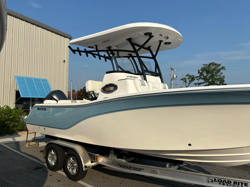 Slide: The Image of 2025 Sea Fox 248 Side Console boat on trailer, parked outdoors. - 6