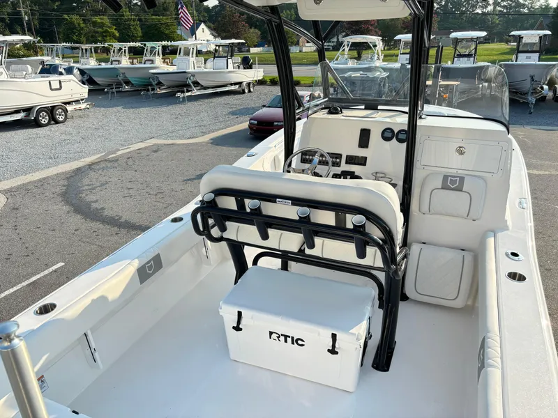 Slide: The Image of 2025 Sea Fox 248 Side Console boat interior with seating and RTIC cooler. - 9