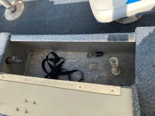 Slide: The Image of Open storage compartment in 1992 Starcraft FM 160C boat with straps and fittings. - 10