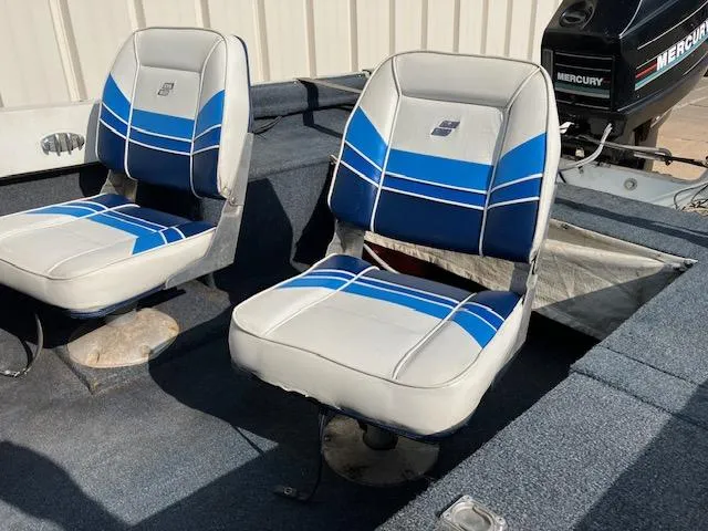 Slide: The Image of 1992 Starcraft FM 160C boat seats with blue and white upholstery, Mercury motor visible. - 11
