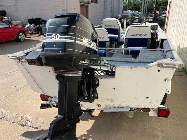 Slide: The Image of 1992 Starcraft FM 160C boat with Mercury 50 outboard motor, parked outdoors. - 12