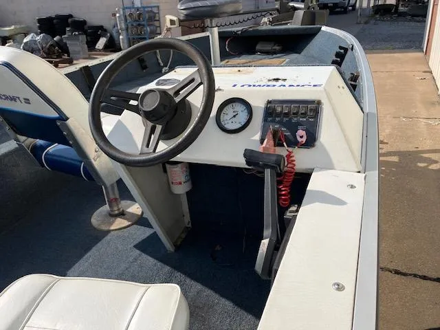 Slide: The Image of 1992 Starcraft FM 160C boat interior with steering wheel and control panel. - 14