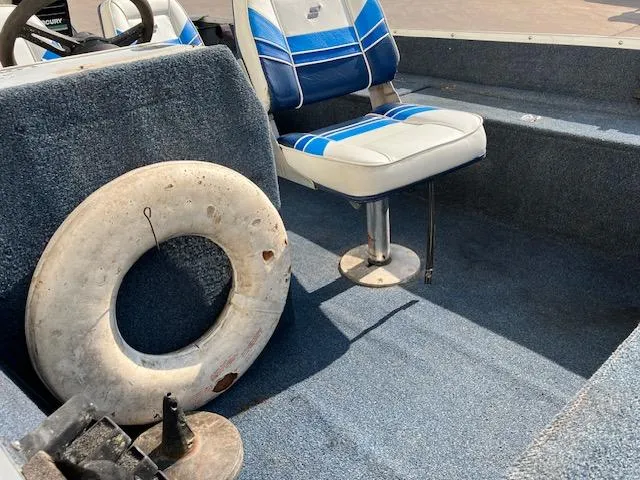 Slide: The Image of 1992 Starcraft FM 160C boat interior with blue seats and life preserver. - 6