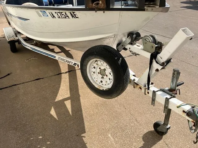 Slide: The Image of 1992 Starcraft FM 160C boat on trailer, close-up of wheel and hitch. - 7
